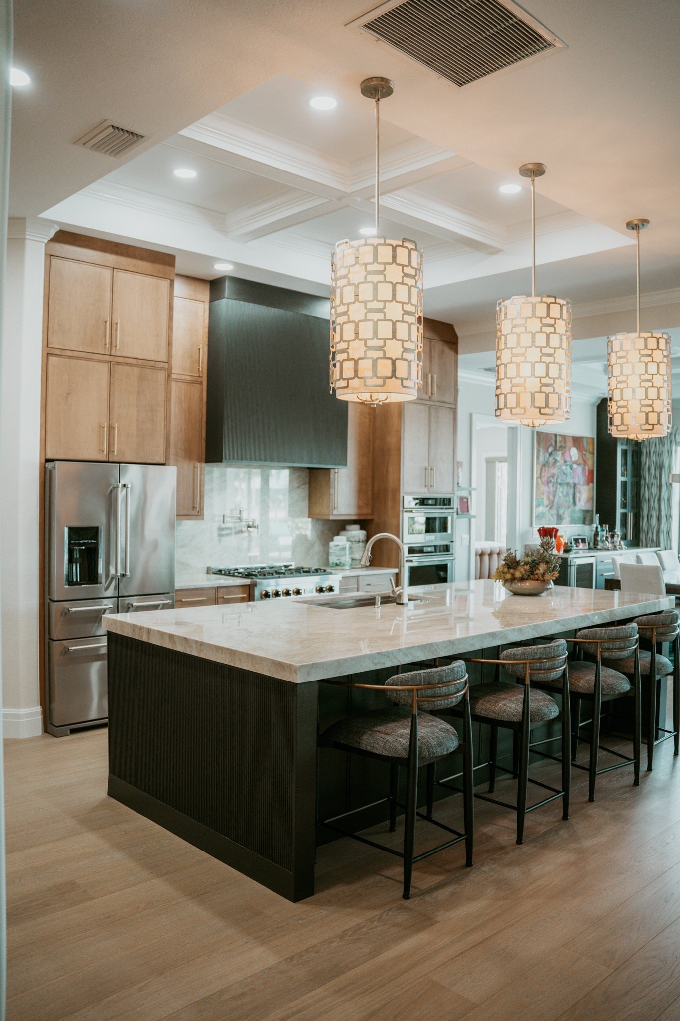 Island with a thick stone top over dark cabinetry, installed by HB