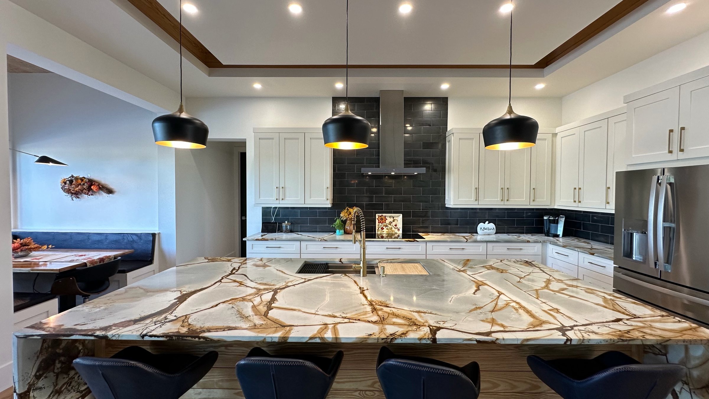 Kitchen island with bold gold veining and waterfall ends